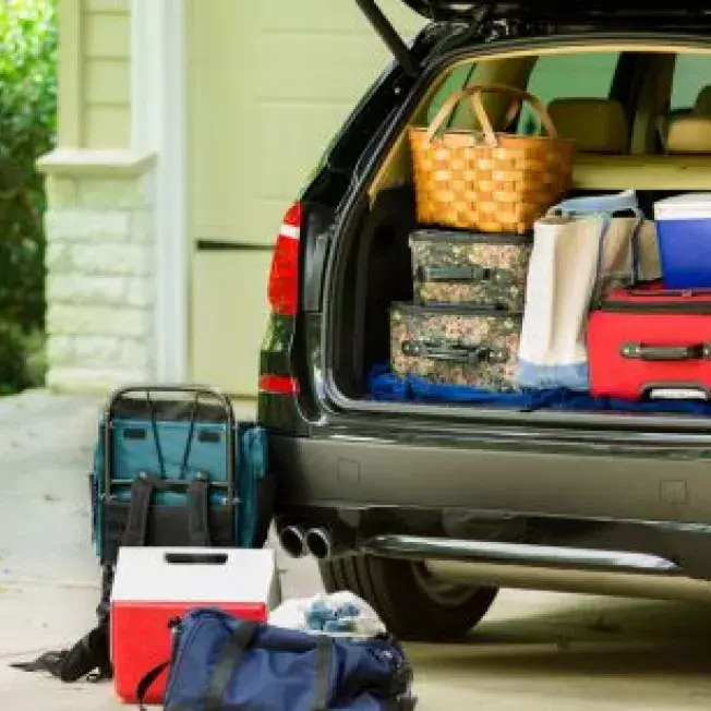 SUV packed for a roadtrip pared in the front driveway of a house