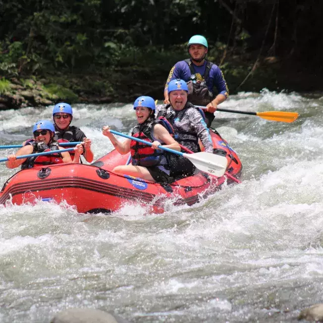 People in an inflatable boat rafting on a disney adventure