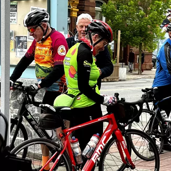 Woman dressed in road cycling clothing preparing to ride