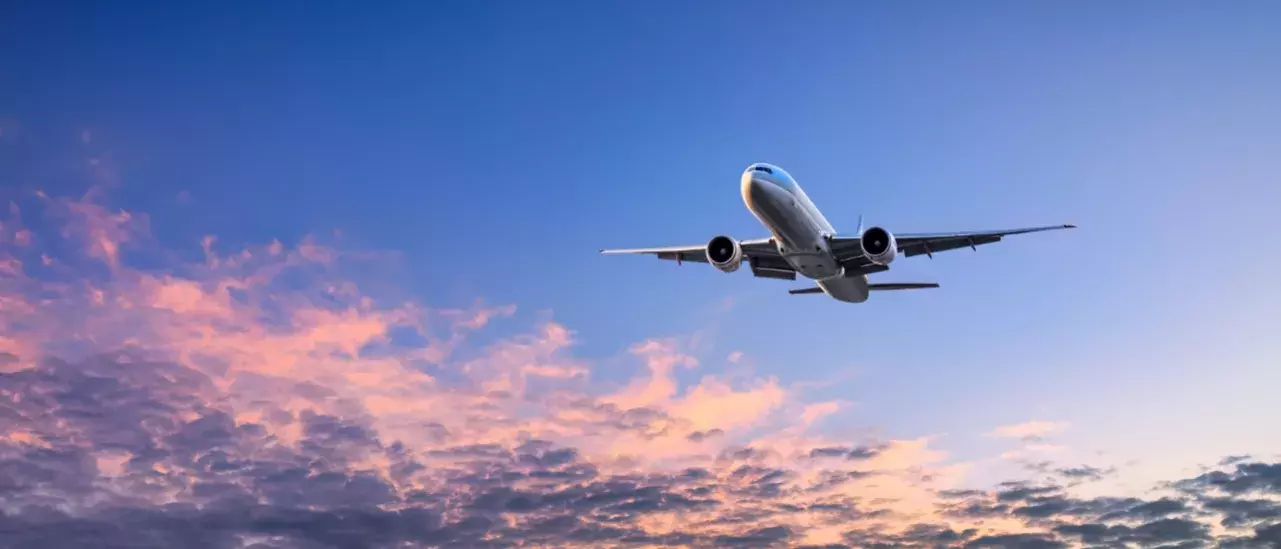 Large Jet Airplane flying over a blue sky