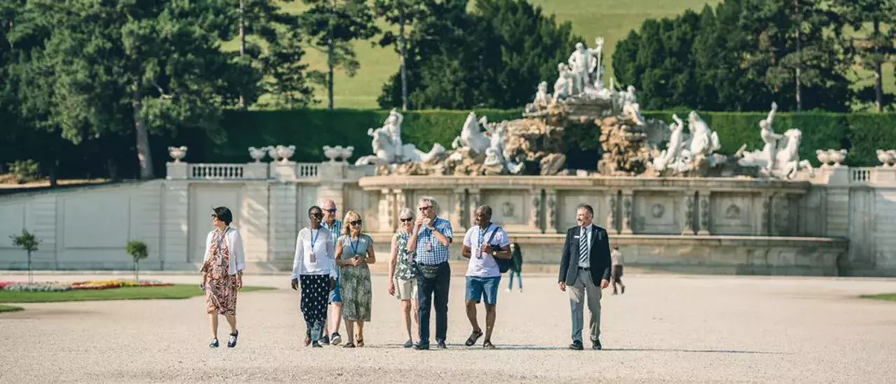 A group of people walking through an open boardwalk