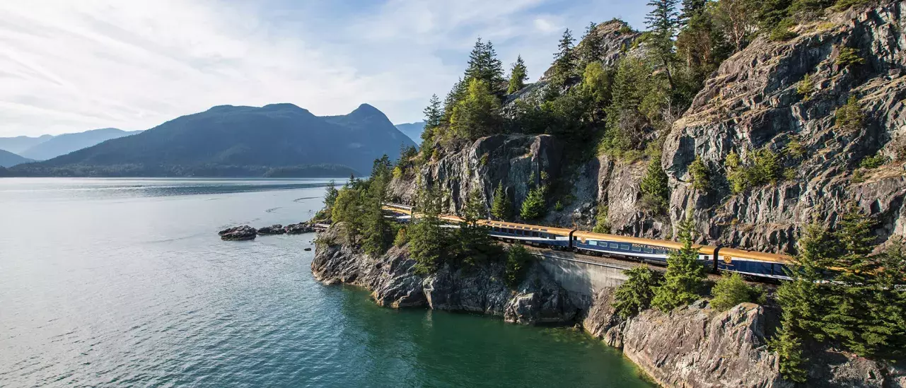 A train moving along a rocky coastline