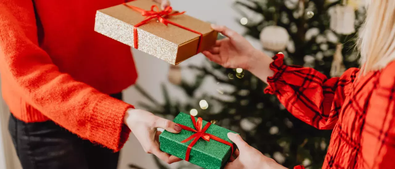 Two people exchanging gifts