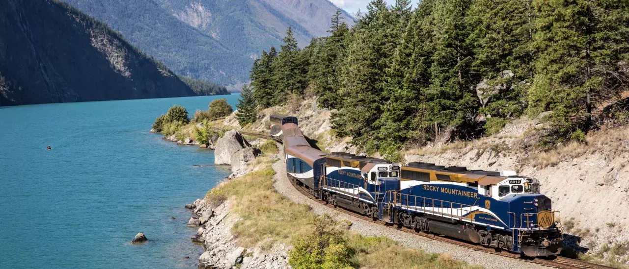 The Rocky Mountaineer train traveling by the Rocky Mountains