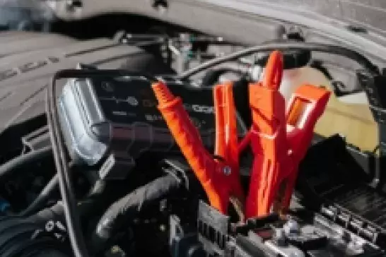 Two red clamps on a car battery