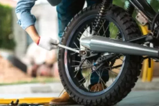 Hand with a wrench to a bike tire