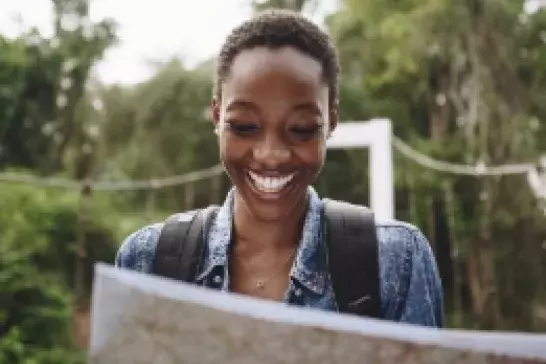 Person reading a map while hiking