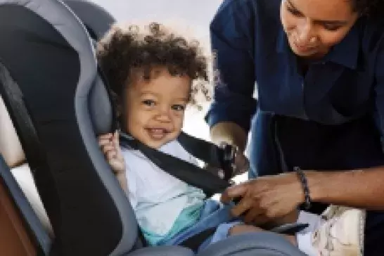 Child getting fastened into a carseat