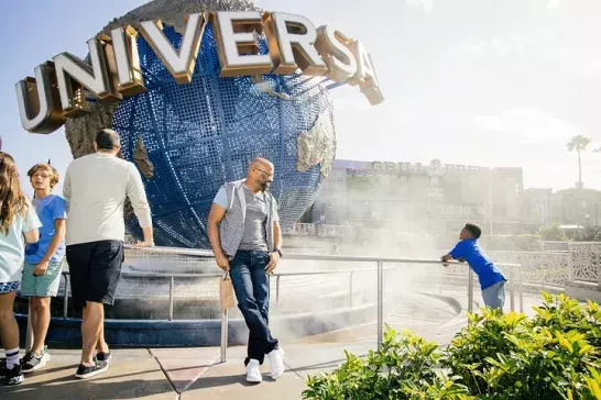 Group of people standing in front of Universal Studios statue