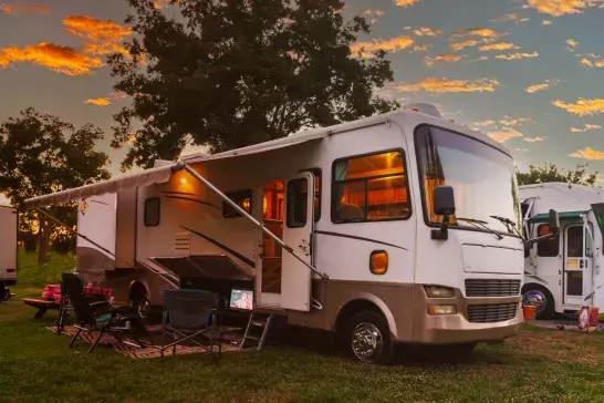 Sun going down at the Rv park with lights on the motor home