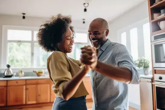 Couple dancing in their home