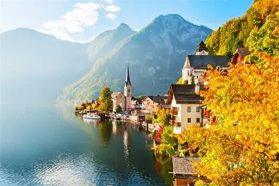 a picturesque lakeside village surrounded by towering mountains. 