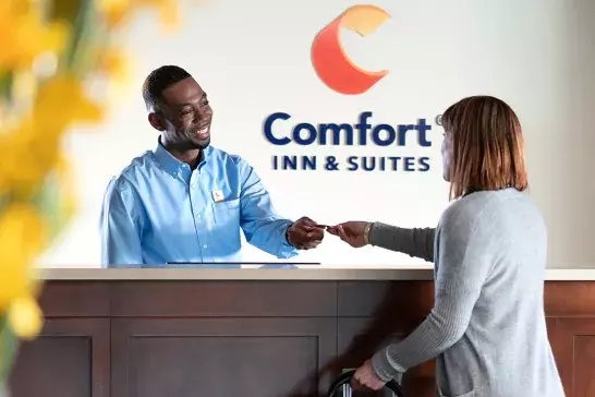 A woman checking into Comfort Inn & Suites
