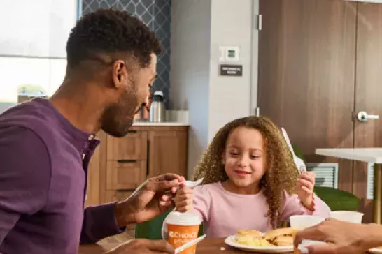 A family eating breakfast at a Choice Hotel location