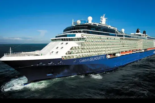 Celebrity Silhouette cruise ship sailing on open ocean under clear blue skies.