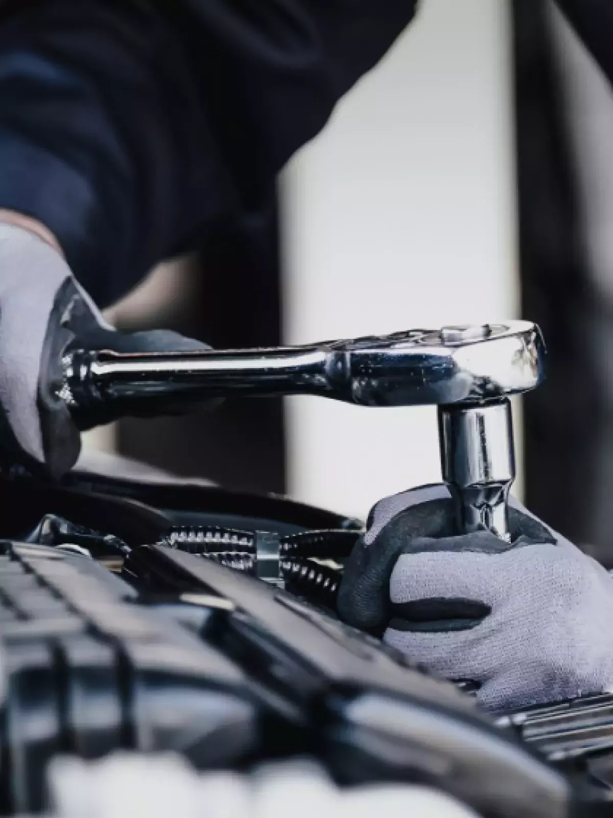 Worker working on an engine with a wrench