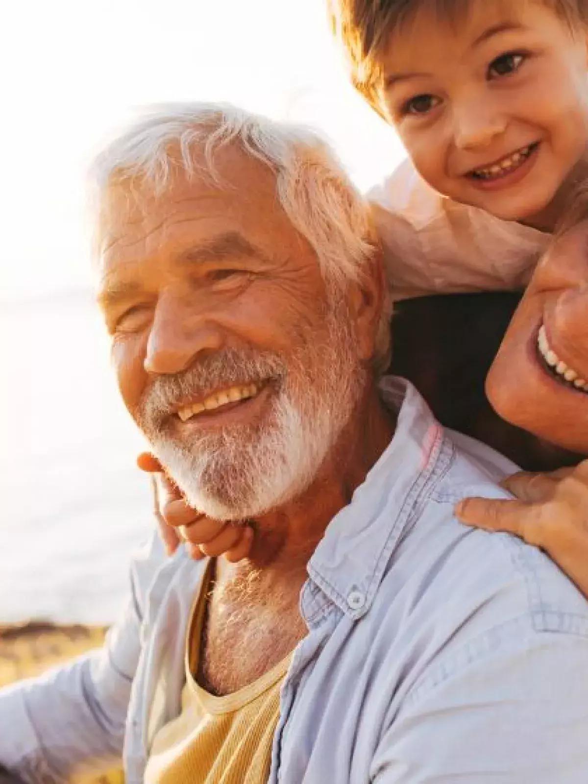 Grandparents with grandchild playing at the beach