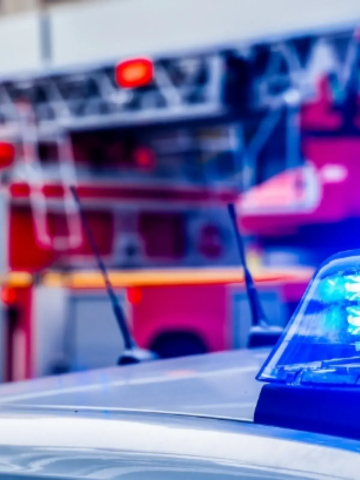 Close up shot of police sirens with a blurred fire truck in the background
