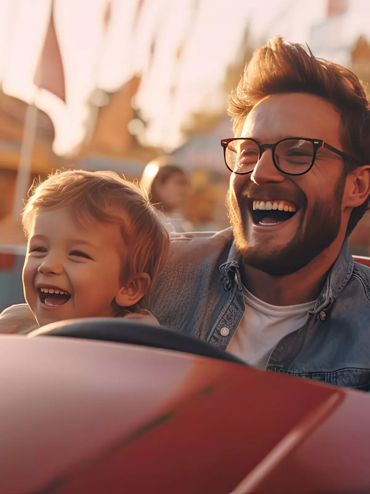 Cheerful father and son and have fun while driving a bumper car in an amusement park. 