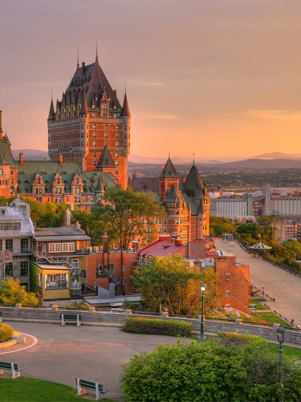 Sunset view of Quebec City with Château Frontenac, historic buildings, and the St. Lawrence River.