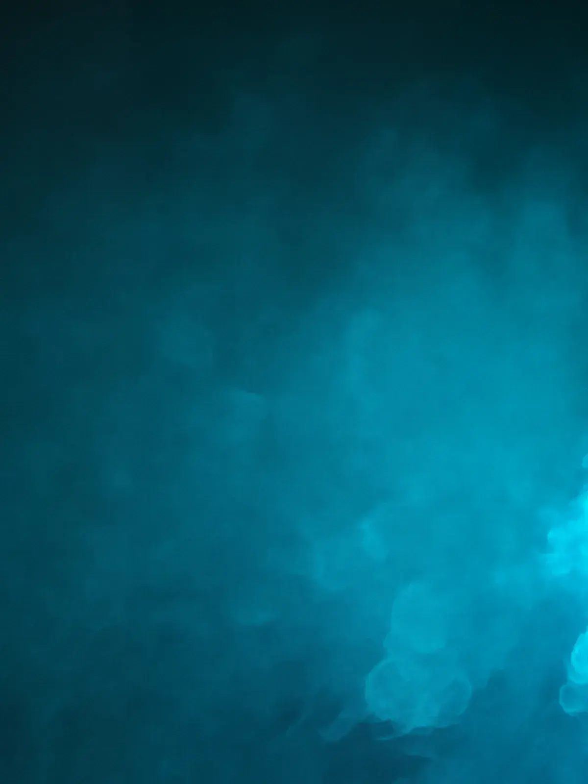 Athlete reaching up to catch a soccer ball in dramatic blue lighting against a dark background.