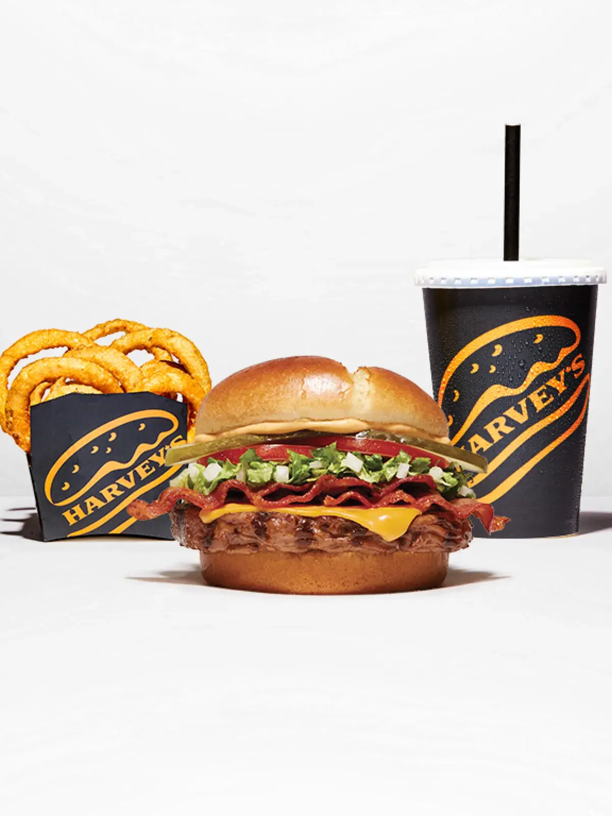 Harvey’s bacon cheeseburger combo with curly fries and a fountain drink.