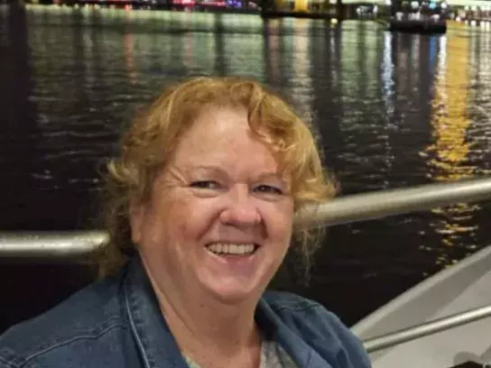 Trish on a boat in front of the Eifel Tower