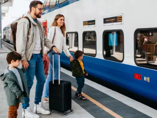 A family waiting to board a train