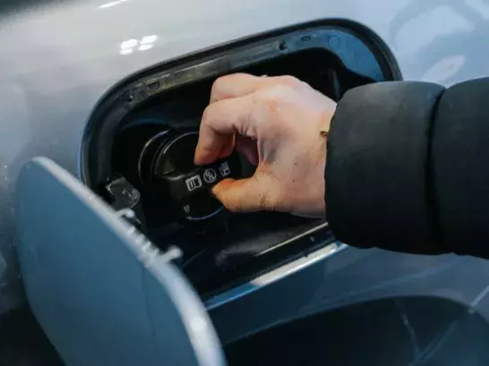 Hand turning a gas cap