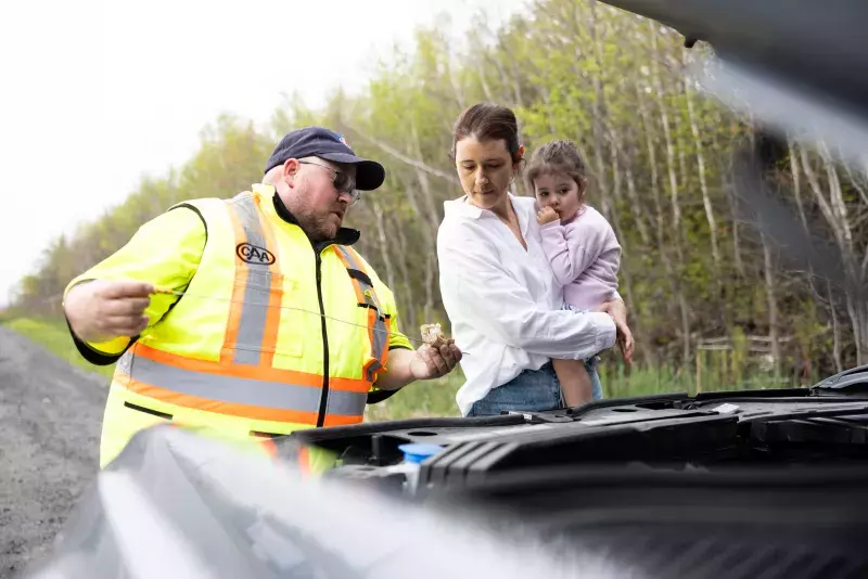 CAA Tow Truck Driver shows a member under the hood and explains what he's checking