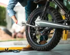 Hand with a wrench to a bike tire