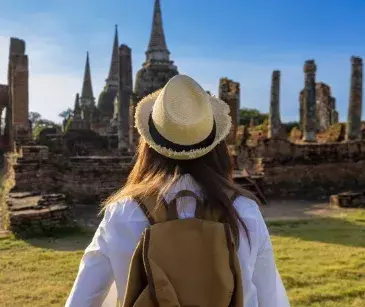 Woman hiking to ancient ruins