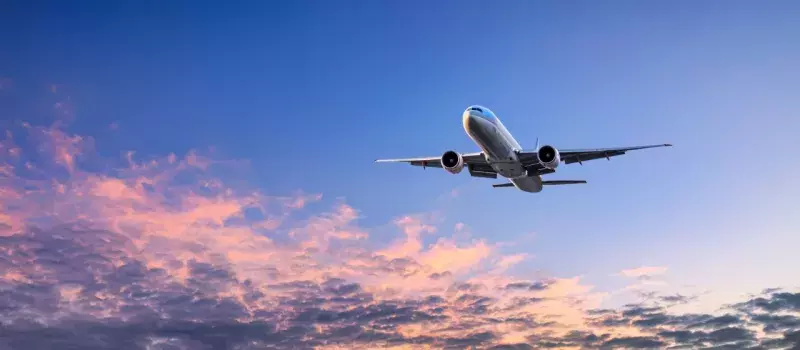 Large Jet Airplane flying over a blue sky
