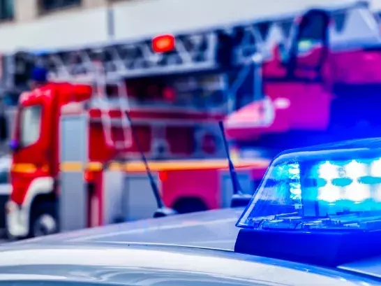 Close up shot of police sirens with a blurred fire truck in the background