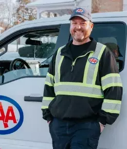 CAA Roadside Assistance driver standing next to his service vehicle