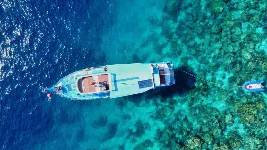 Fishing boat anchored in clear blue waters