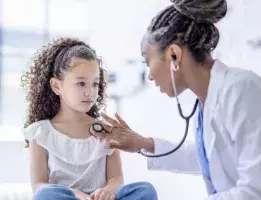 A doctor checking examining a small child