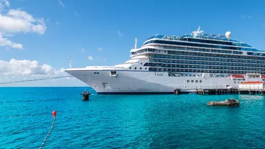 Cruise ship in tropical waters docked at a dock