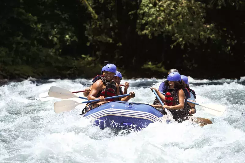 group of people white water rafting