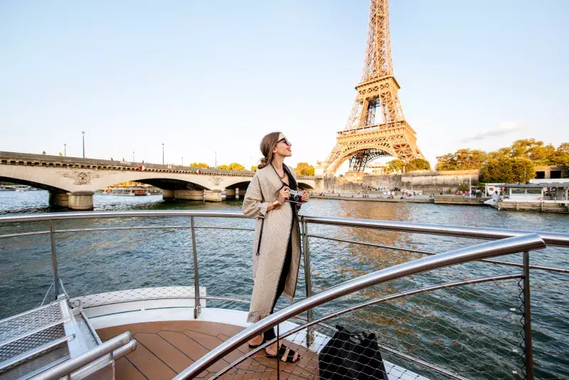 Woman on a boat with her camera in Paris