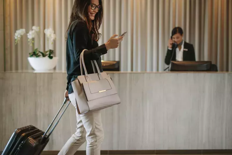 Business traveler in hotel hallway with phone